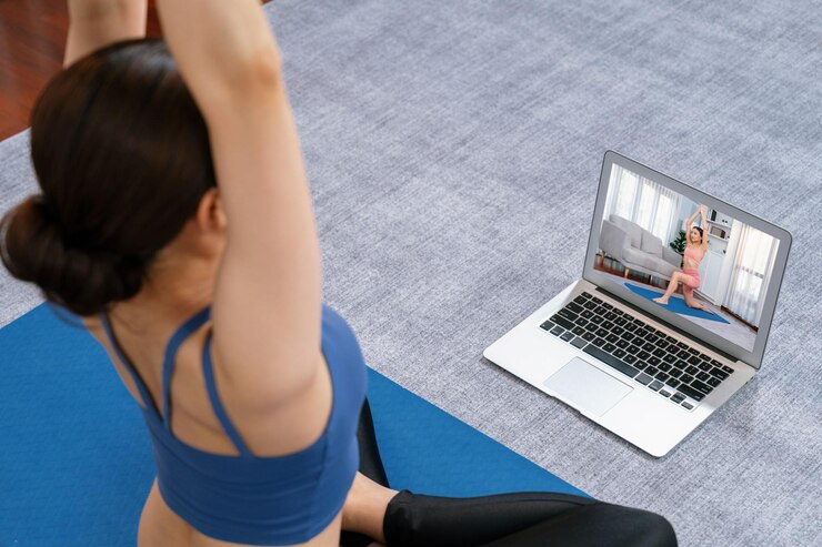asian-woman-sportswear-doing-yoga-exercise-fitness-mat-as-her-home-workout-training-routine-healthy-body-care-lifestyle-woman-watching-online-yoga-video-laptop-vigorous_31965-242768