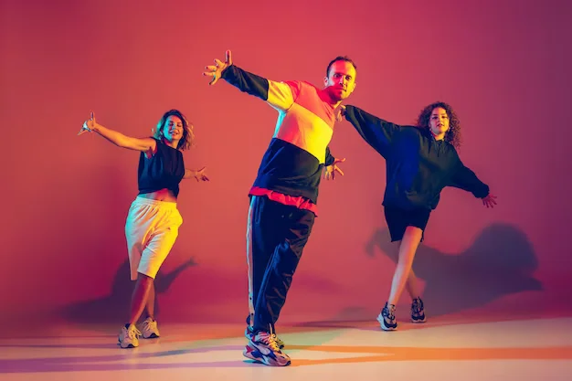 stylish-young-man-women-dancing-hip-hop-bright-clothes-gradient-background-dance-hall-neon-light-youth-culture-movement-style-fashion-action-hip-hop-fashionable-portrait_489646-12413